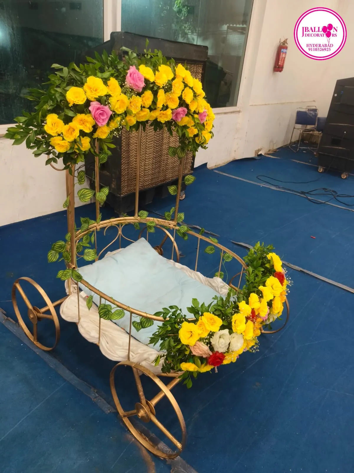 Baby cart decorated with fresh flowers for cradle and naming ceremony